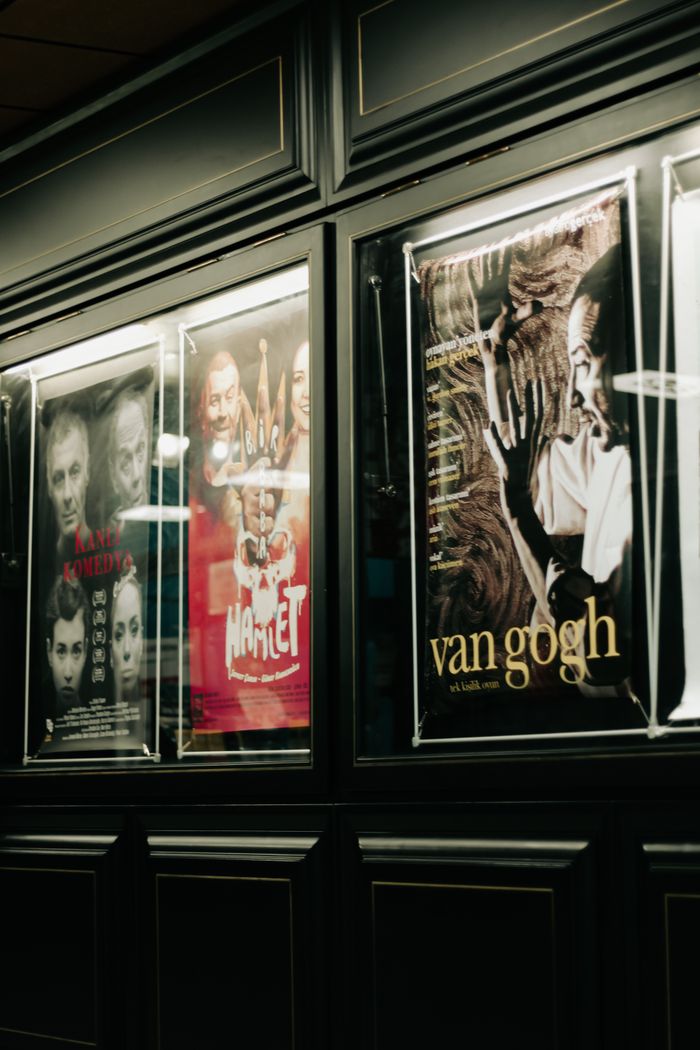 A collection of movie posters displayed on a sleek dark wall, creating a stylish interior vibe.